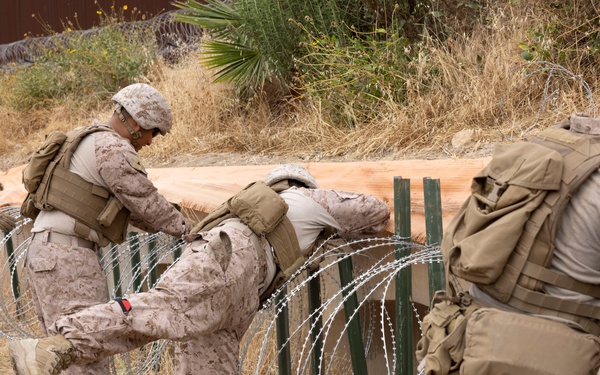 U.S. Marines with Task Force Sapper adjust concertina wire