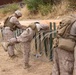 U.S. Marines with Task Force Sapper adjust concertina wire
