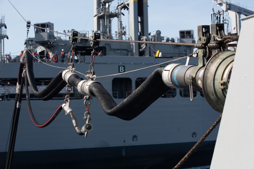 USS Benfold (DDG 65) conducts a replenishment at sea in the South China Sea