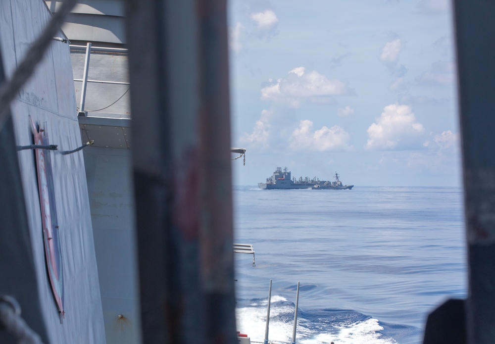 USS Benfold (DDG 65) conducts a replenishment at sea in the South China Sea
