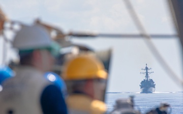 USS Benfold (DDG 65) conducts a replenishment at sea in the South China Sea