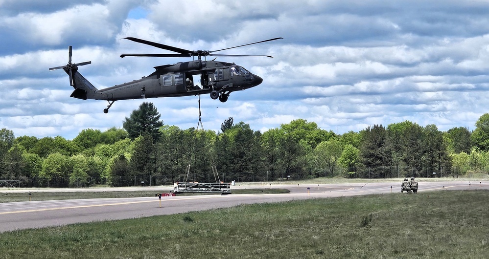 Soldiers with 13th Battalion, 100th Regiment hold slingload training at McCoy, Wisconsin National Guard Black Hawks, crews assist