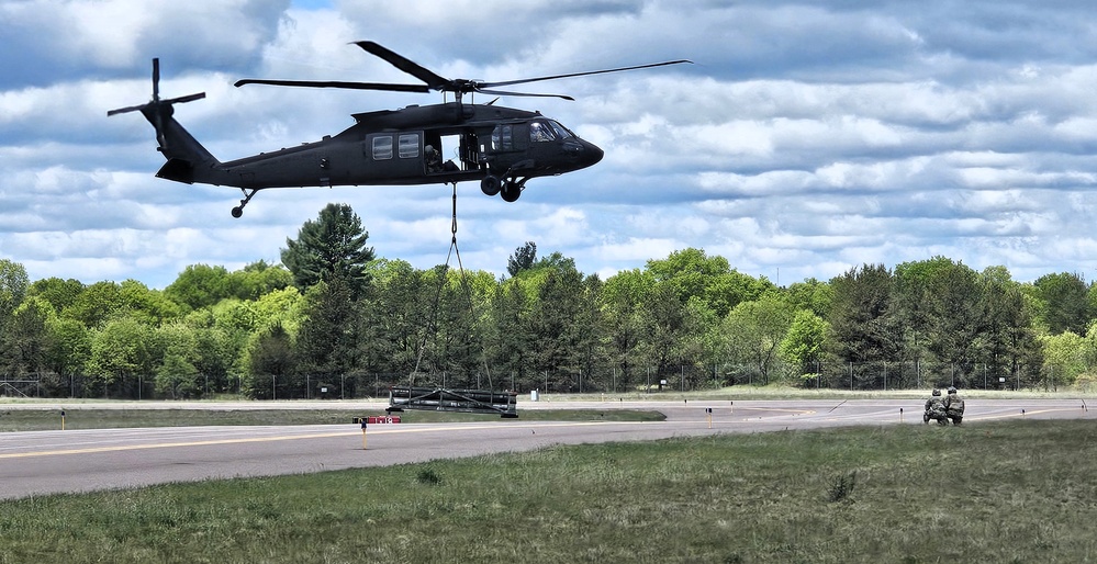 Soldiers with 13th Battalion, 100th Regiment hold slingload training at McCoy, Wisconsin National Guard Black Hawks, crews assist