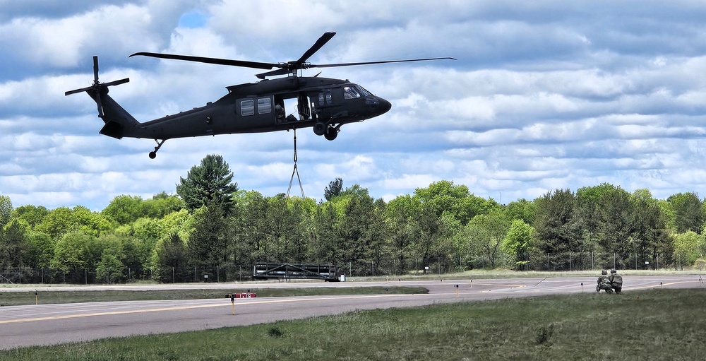 Soldiers with 13th Battalion, 100th Regiment hold slingload training at McCoy, Wisconsin National Guard Black Hawks, crews assist