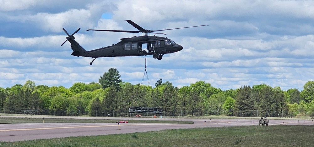 Soldiers with 13th Battalion, 100th Regiment hold slingload training at McCoy, Wisconsin National Guard Black Hawks, crews assist