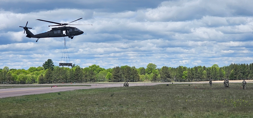 Soldiers with 13th Battalion, 100th Regiment hold slingload training at McCoy, Wisconsin National Guard Black Hawks, crews assist
