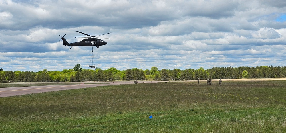 Soldiers with 13th Battalion, 100th Regiment hold slingload training at McCoy, Wisconsin National Guard Black Hawks, crews assist