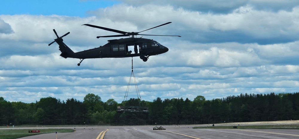 Soldiers with 13th Battalion, 100th Regiment hold slingload training at McCoy, Wisconsin National Guard Black Hawks, crews assist
