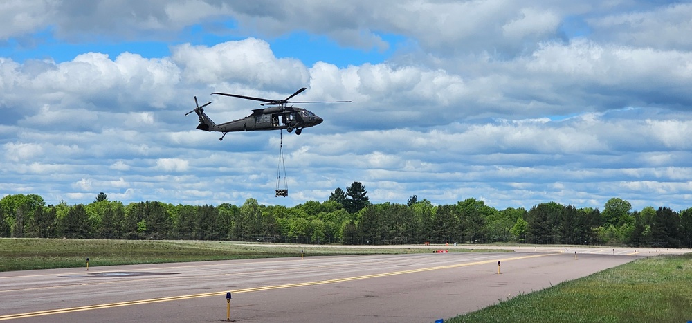 Soldiers with 13th Battalion, 100th Regiment hold slingload training at McCoy, Wisconsin National Guard Black Hawks, crews assist
