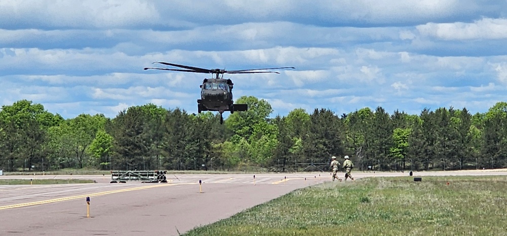 Soldiers with 13th Battalion, 100th Regiment hold slingload training at McCoy, Wisconsin National Guard Black Hawks, crews assist