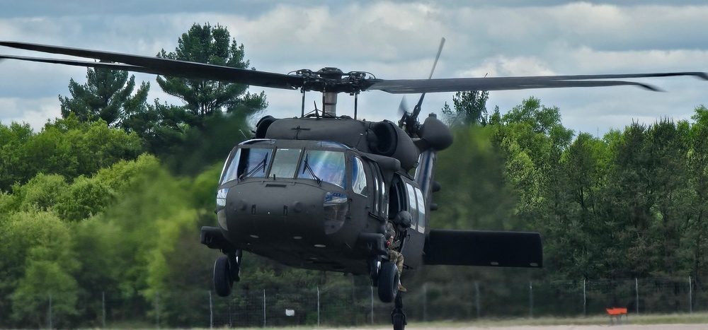 Soldiers with 13th Battalion, 100th Regiment hold slingload training at McCoy, Wisconsin National Guard Black Hawks, crews assist