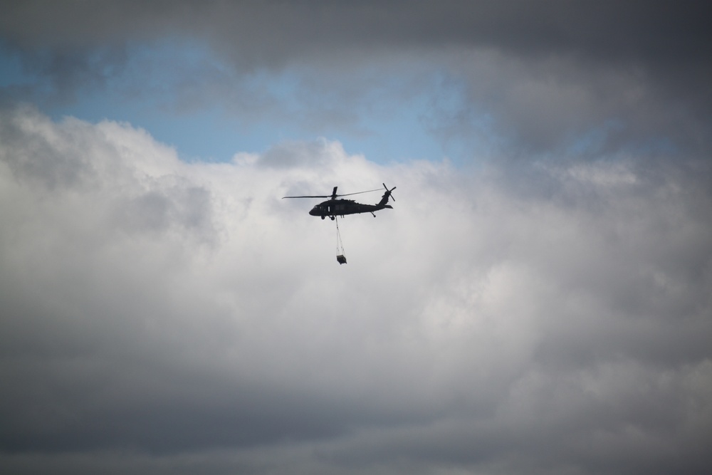 Soldiers with 13th Battalion, 100th Regiment hold slingload training at McCoy, Wisconsin National Guard Black Hawks, crews assist