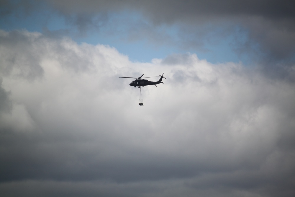 Soldiers with 13th Battalion, 100th Regiment hold slingload training at McCoy, Wisconsin National Guard Black Hawks, crews assist