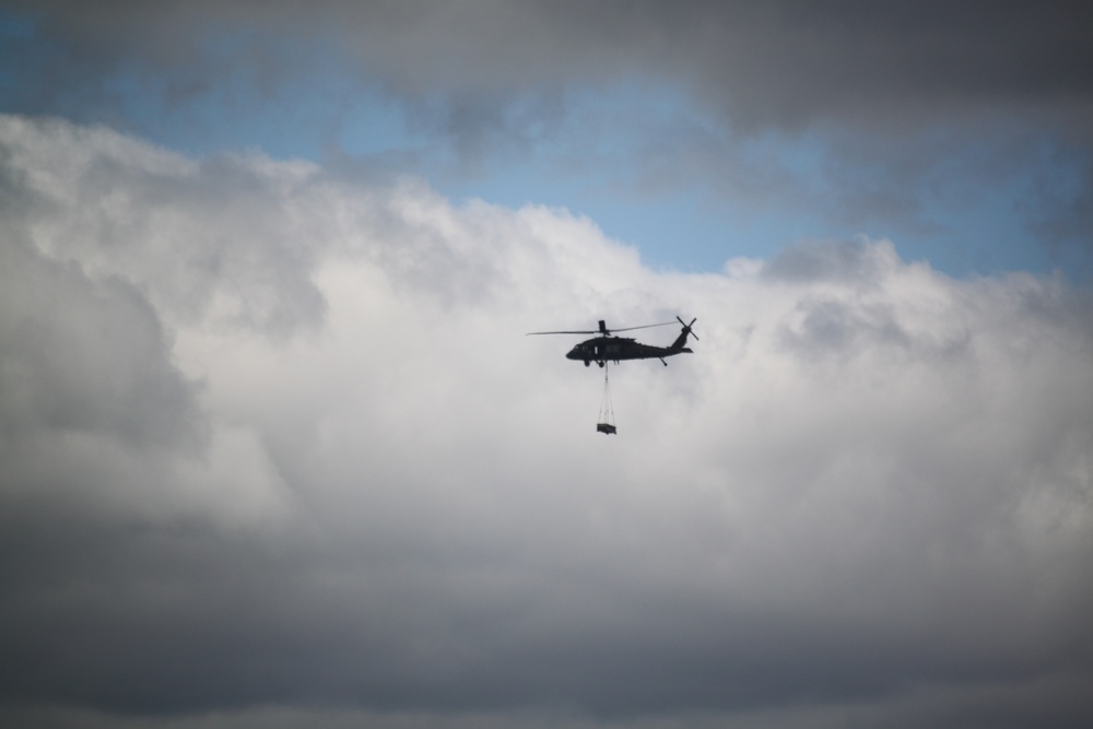 Soldiers with 13th Battalion, 100th Regiment hold slingload training at McCoy, Wisconsin National Guard Black Hawks, crews assist