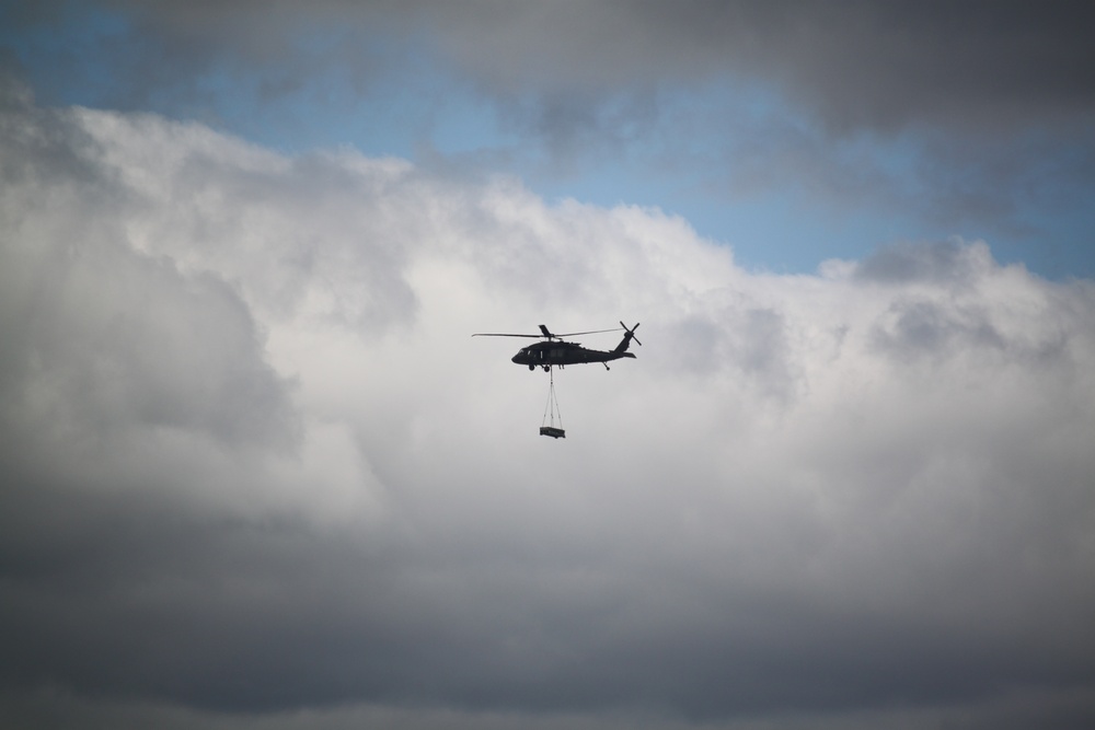 Soldiers with 13th Battalion, 100th Regiment hold slingload training at McCoy, Wisconsin National Guard Black Hawks, crews assist