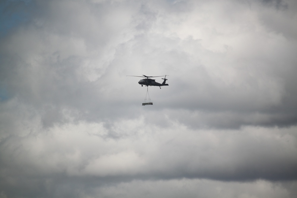 Soldiers with 13th Battalion, 100th Regiment hold slingload training at McCoy, Wisconsin National Guard Black Hawks, crews assist