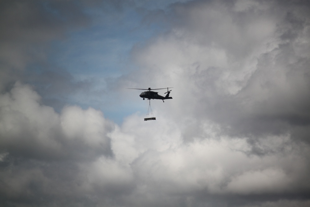 Soldiers with 13th Battalion, 100th Regiment hold slingload training at McCoy, Wisconsin National Guard Black Hawks, crews assist