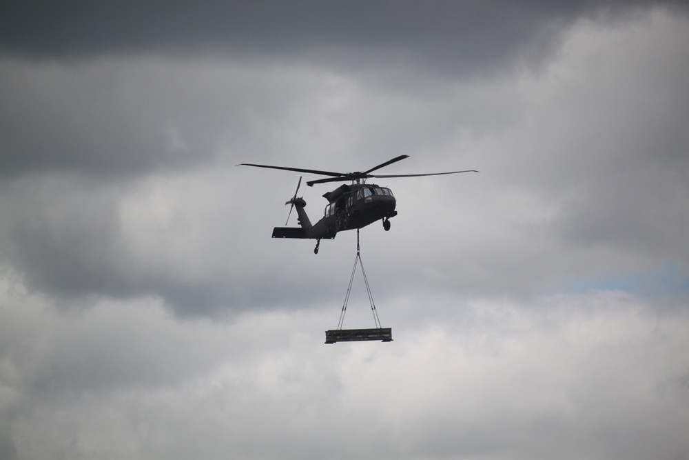Soldiers with 13th Battalion, 100th Regiment hold slingload training at McCoy, Wisconsin National Guard Black Hawks, crews assist