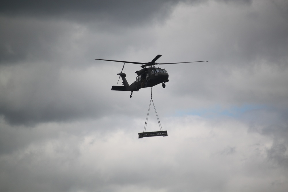 Soldiers with 13th Battalion, 100th Regiment hold slingload training at McCoy, Wisconsin National Guard Black Hawks, crews assist