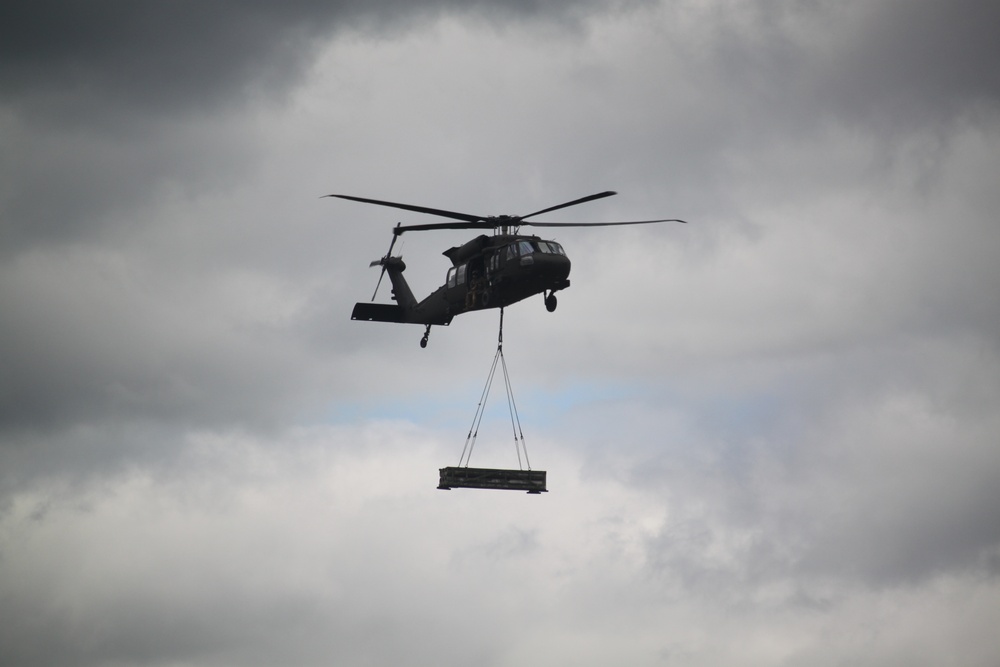 Soldiers with 13th Battalion, 100th Regiment hold slingload training at McCoy, Wisconsin National Guard Black Hawks, crews assist