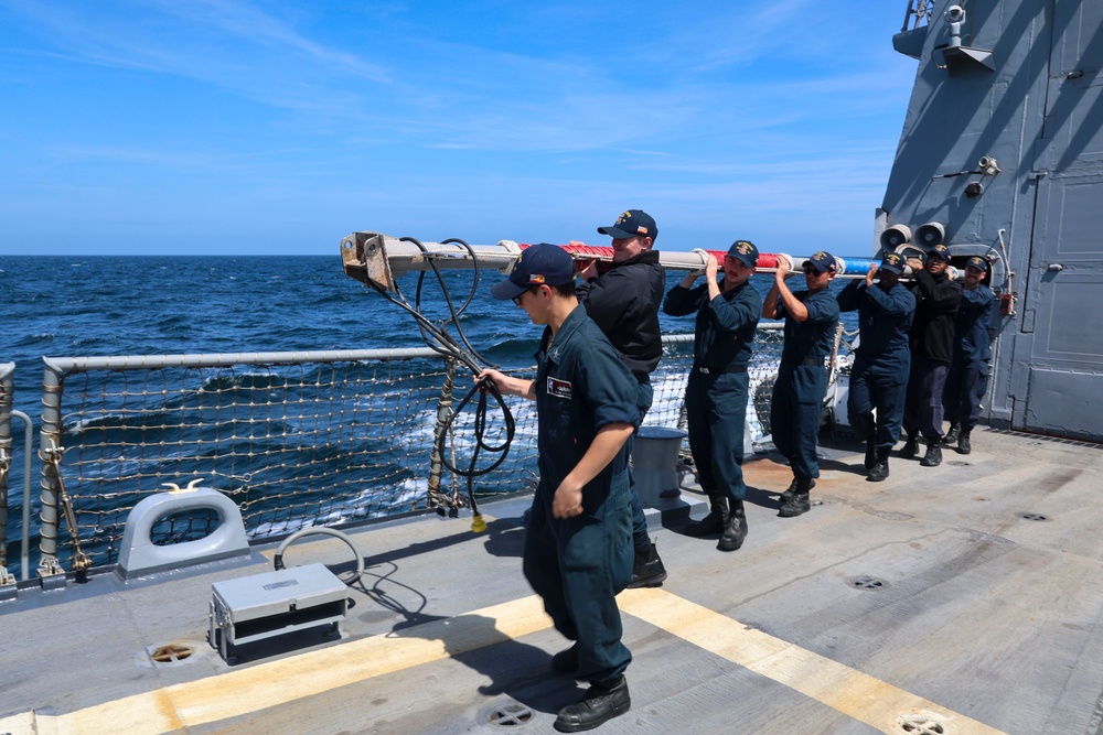 U.S. Navy #wolfpack Sailors transport the aft flag staff to the flight deck