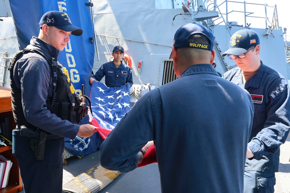 U.S. Navy #wolfpack Sailors fold and stow the ensign