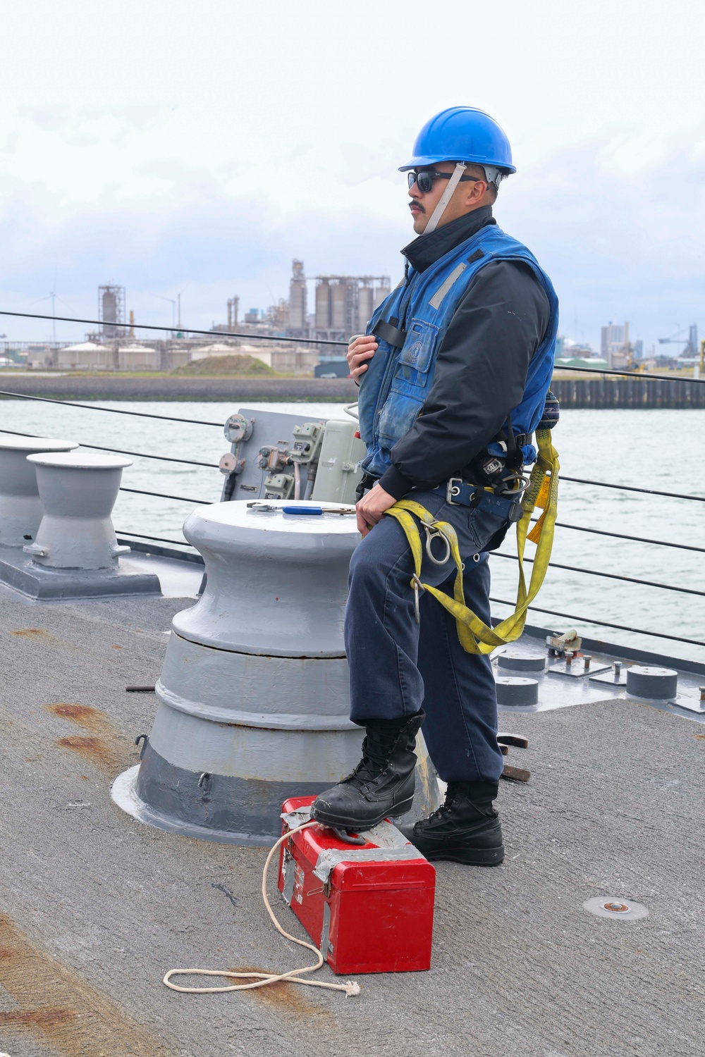 Boatswain’s Mate 3rd Class James Mark Monje prepares to lower the jack staff