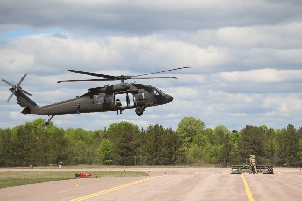 Soldiers with 13th Battalion, 100th Regiment hold slingload training at McCoy, Wisconsin National Guard Black Hawks, crews assist