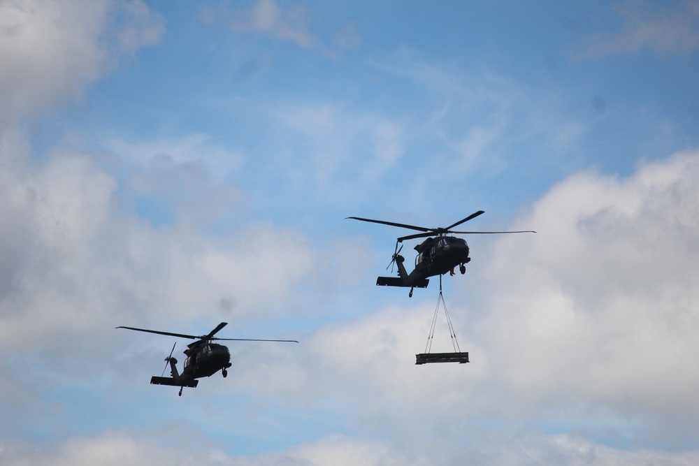 Soldiers with 13th Battalion, 100th Regiment hold slingload training at McCoy, Wisconsin National Guard Black Hawks, crews assist