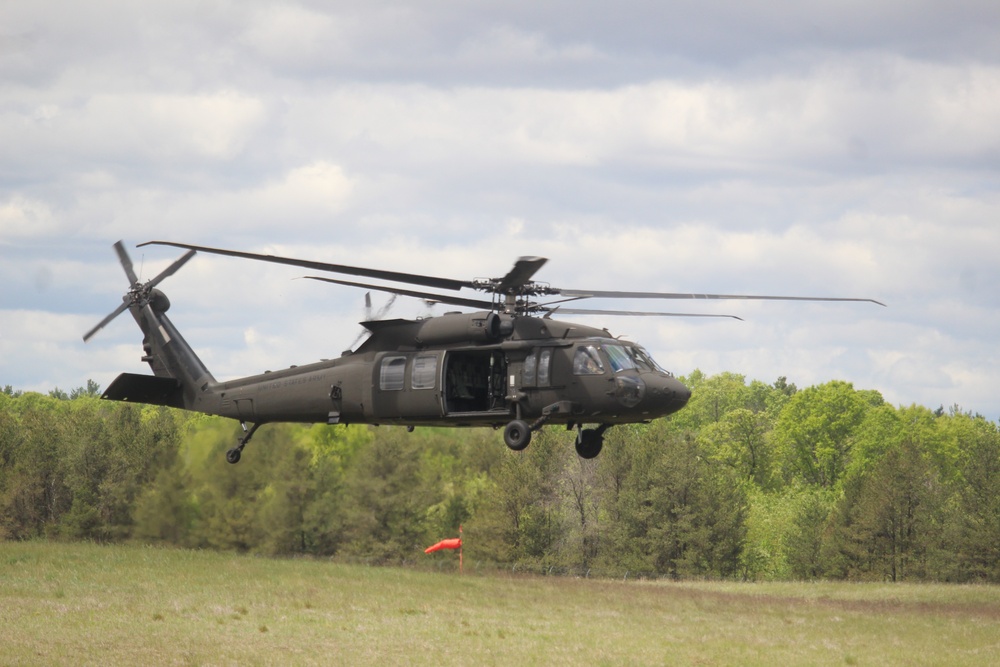 Soldiers with 13th Battalion, 100th Regiment hold slingload training at McCoy, Wisconsin National Guard Black Hawks, crews assist