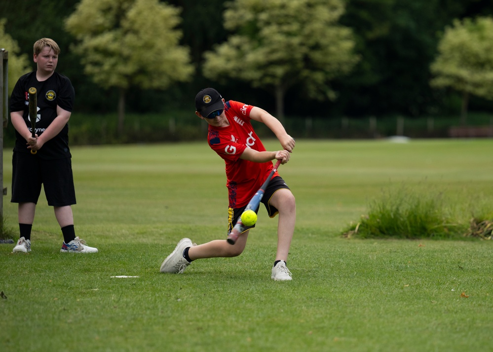 U.S. service members play cricket and softball with local nationals