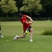 U.S. service members play cricket and softball with local nationals