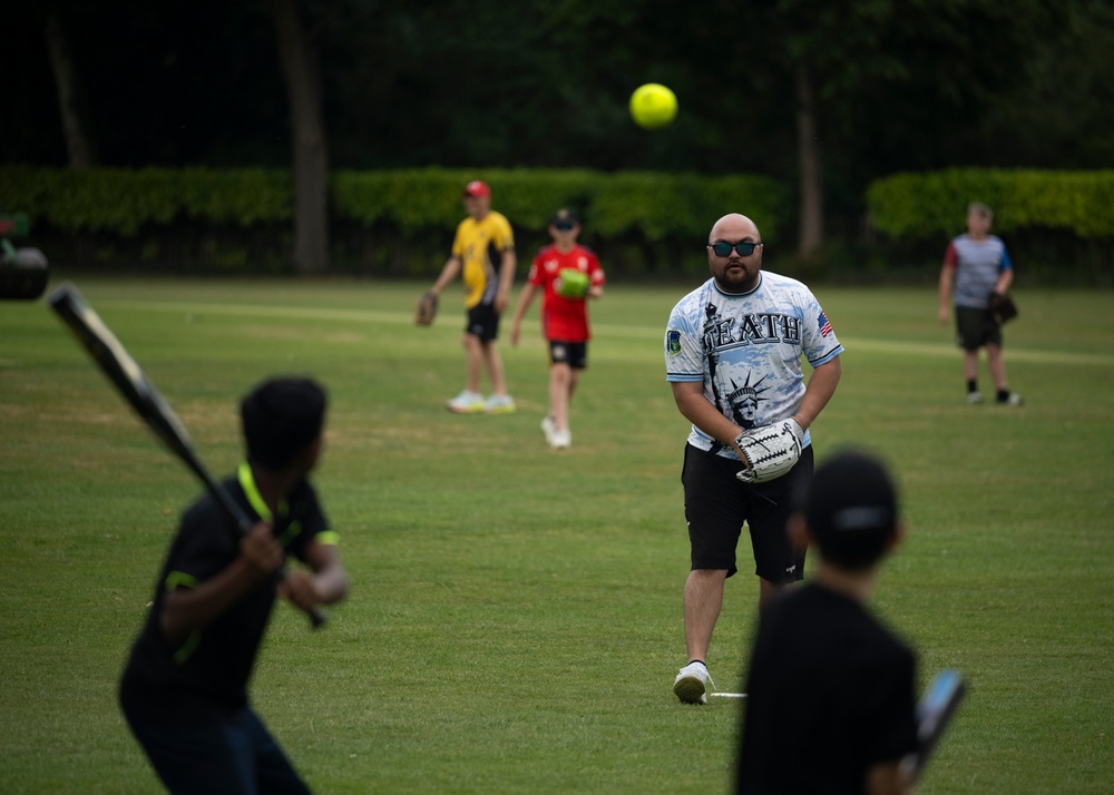 U.S. service members play cricket and softball with local nationals