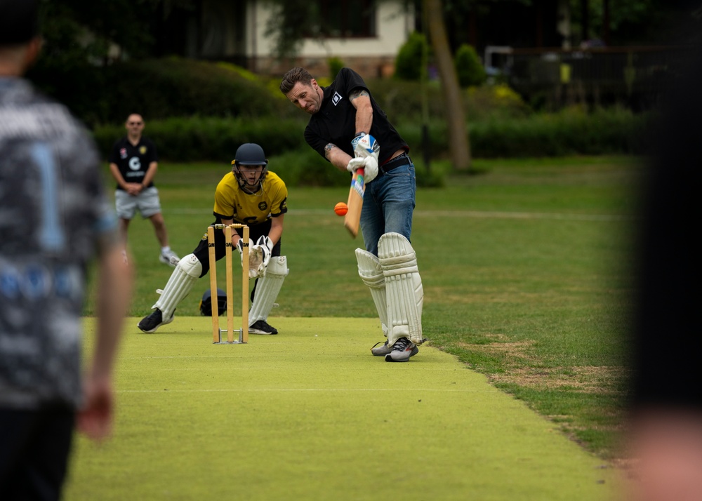 U.S. service members play cricket and softball with local nationals