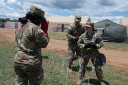 151st CBRN Battalion emplaces concertina wire during Immediate Response 25 [Image 1 of 5]