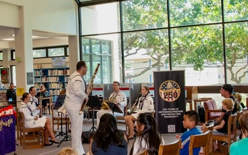 Musician 3rd Class Colin Walter gives a bassoon demonstration for audience members during a U.S. Pacific Fleet Band Woodwind Quintet performance  at the Salt Lake- Moanalua branch of the Hawaii State Library System.