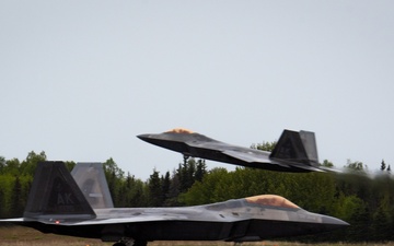F-22 Raptors assigned to JBER conduct aerial maneuvers during exercise Tropic Tundra
