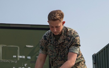 U.S. Marine inspects gear in Osan Air Base