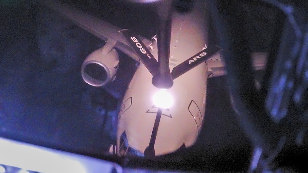 U.S. Navy, 909th ARS perform night training over the Pacific