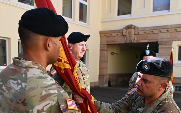 838th Transportation BN Senior Enlisted Leader Hands the Unit Colors to Outgoing 838th Transportation BN Commander
