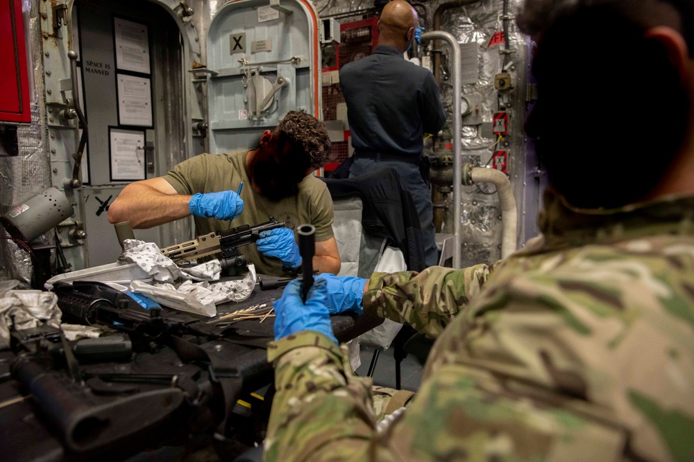 A U.S. Coast Guard Law Enforcement Detachment conducts weapons maintenance with U.S. Navy Sailors onboard the USS Charleston