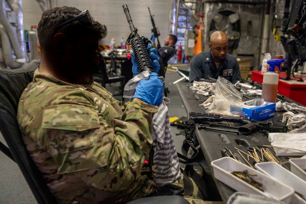 A U.S. Coast Guard Law Enforcement Detachment conducts weapons maintenance with U.S. Navy Sailors onboard the USS Charleston