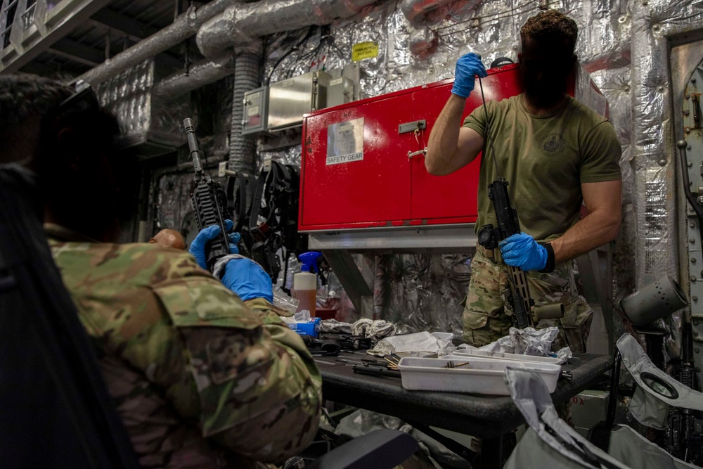 A U.S. Coast Guard Law Enforcement Detachment conducts weapons maintenance with U.S. Navy Sailors onboard the USS Charleston