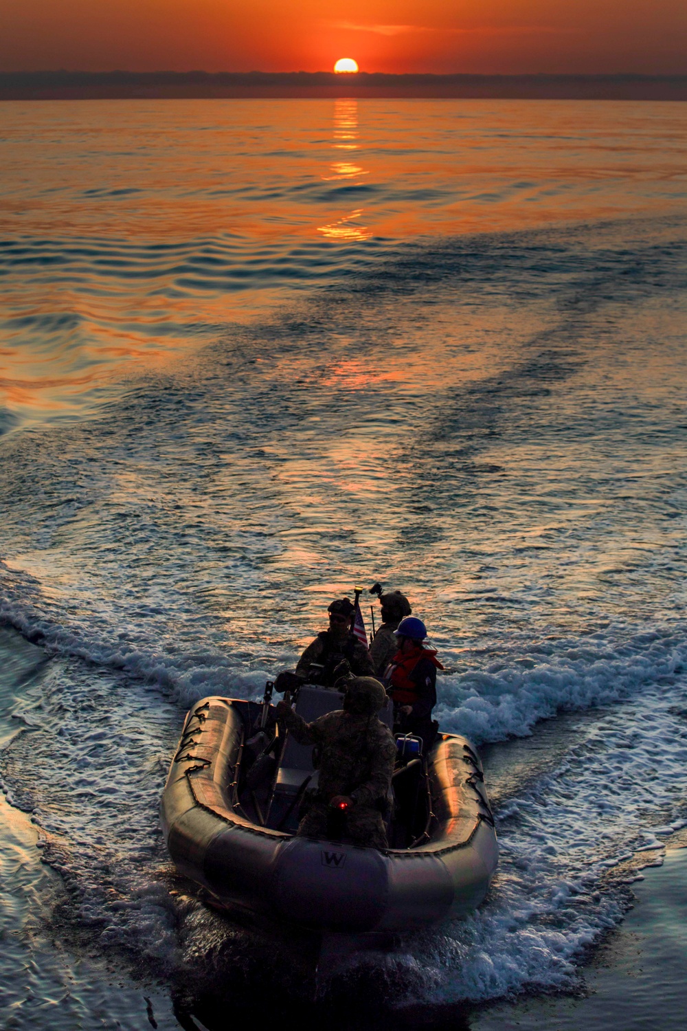 USS Charleston (LCS-18) conducts small boat operations with U.S. Coast Guard