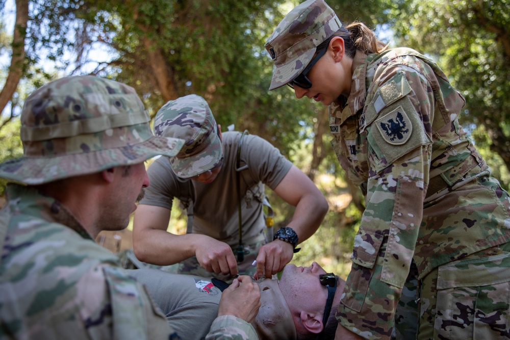 Soldiers run through combat medic specialist training lanes during Exercise Global Medic