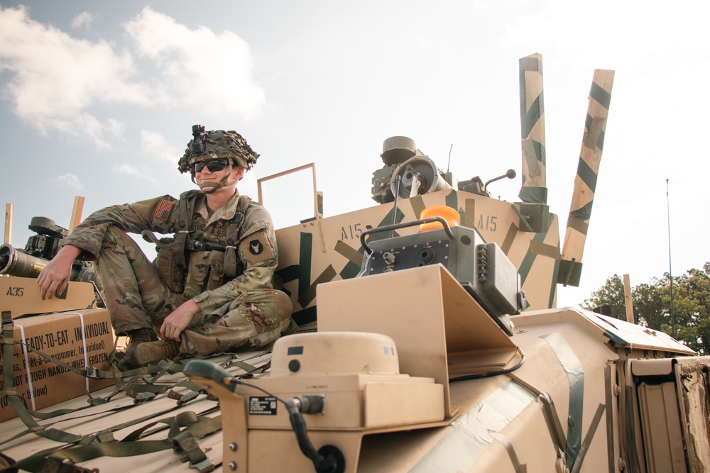 Iowa Army National Guard Cavalry Scout sits on HUMVEE