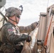 Iowa Army National Guard Soldier installs camouflage netting
