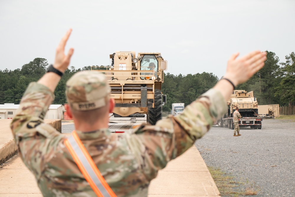 Iowa Army National Guard Soldier directs heavy machinery