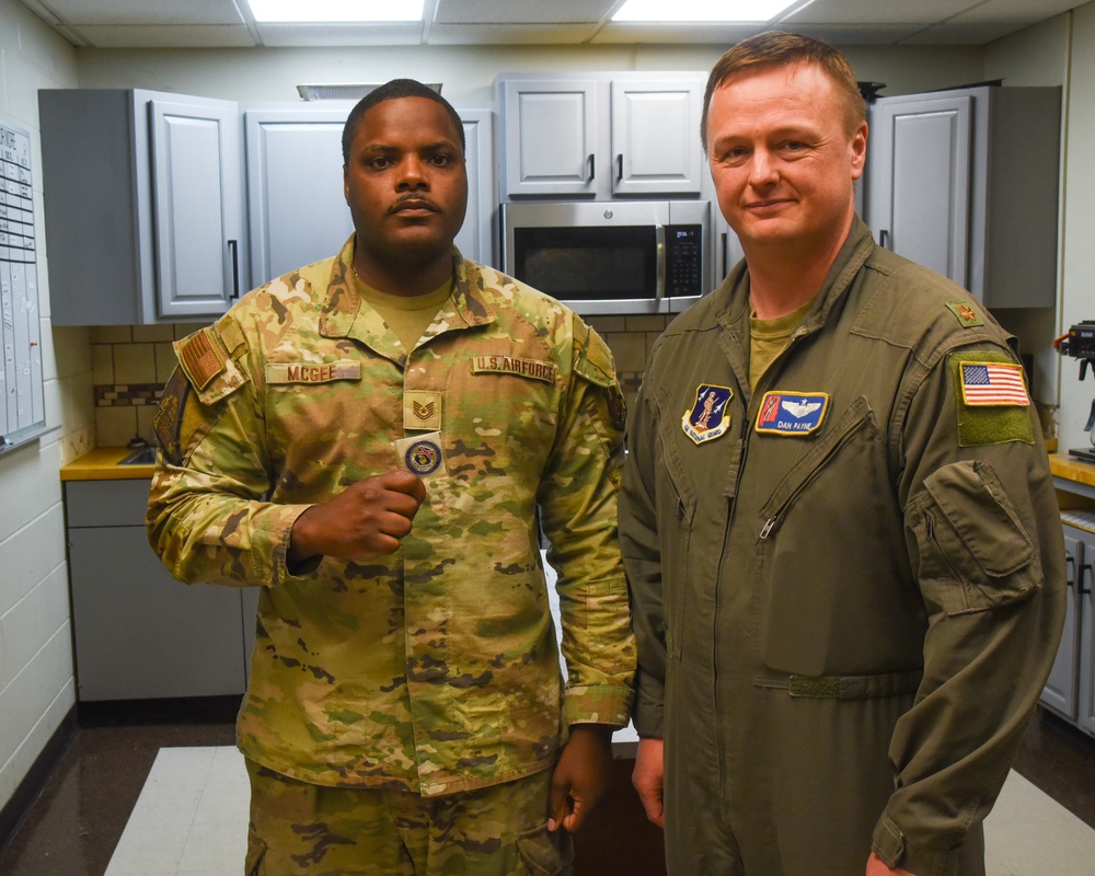 TSGT McGee is presented a coin
