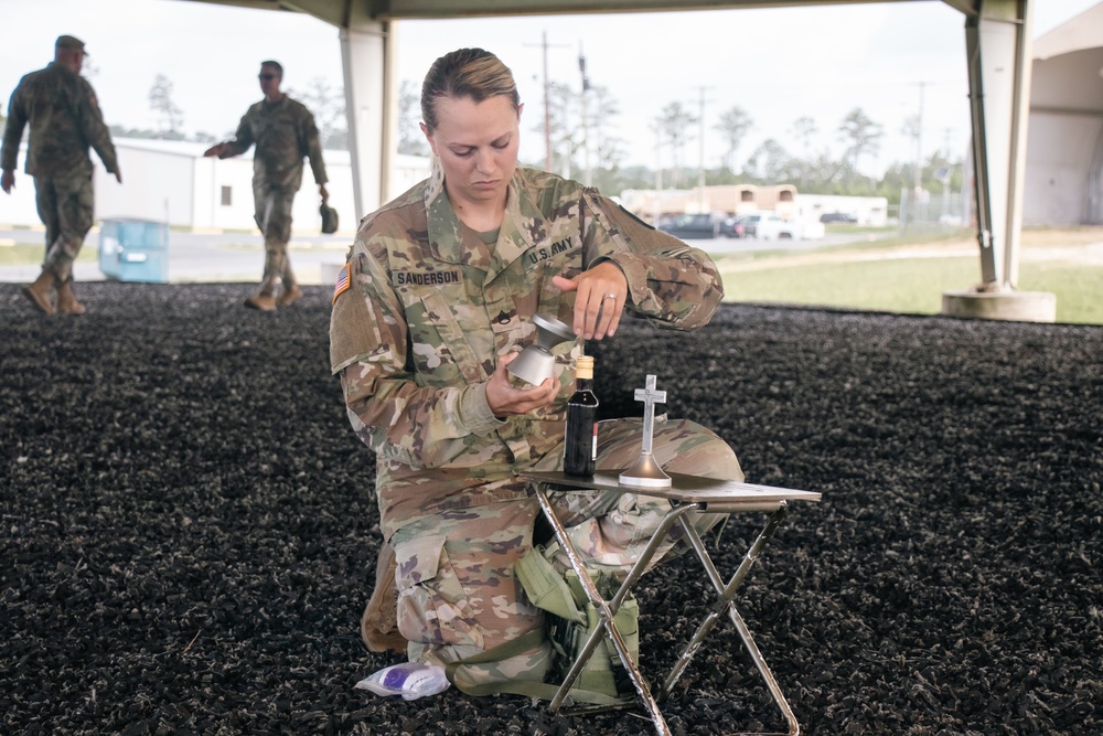 Religious Affairs NCO prepares Sunday chapel service communion